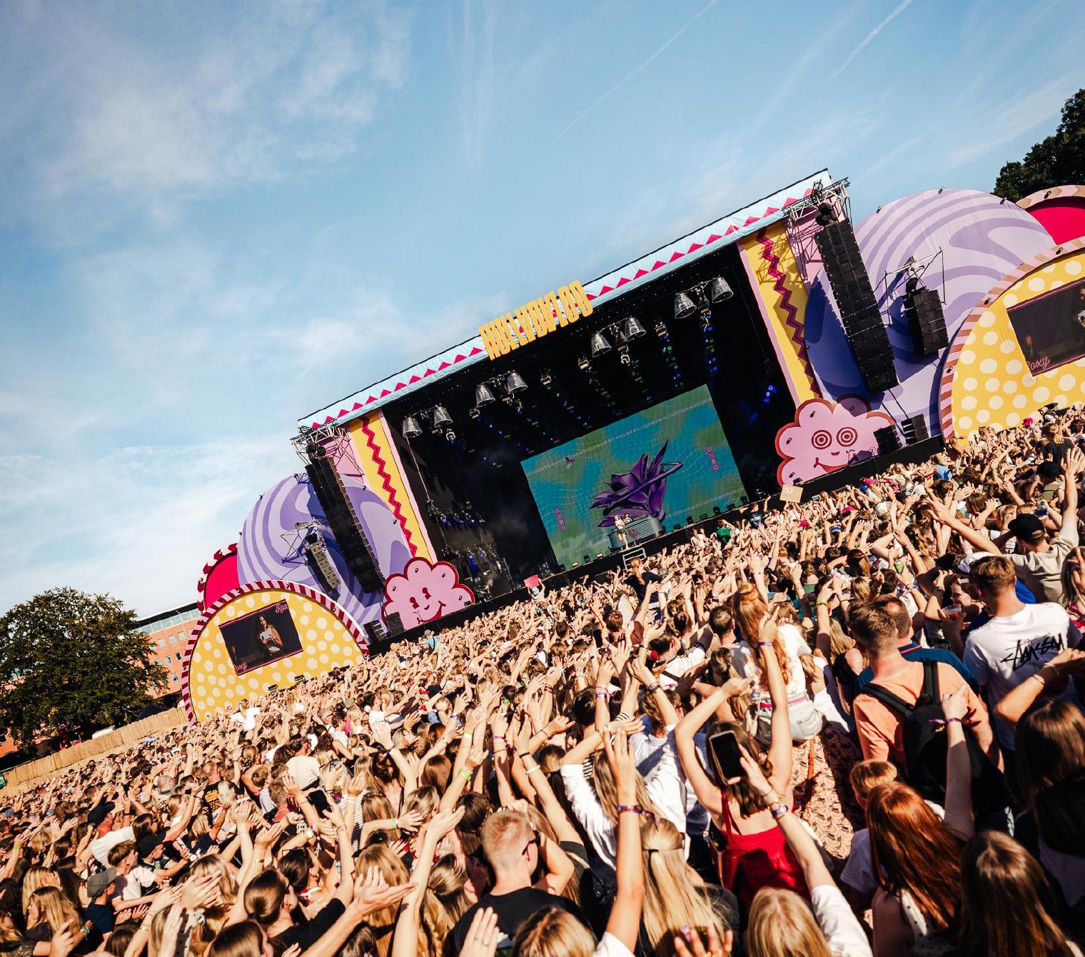 Crowd with their hands in the air in front of the Hullabaloo Festival main stage