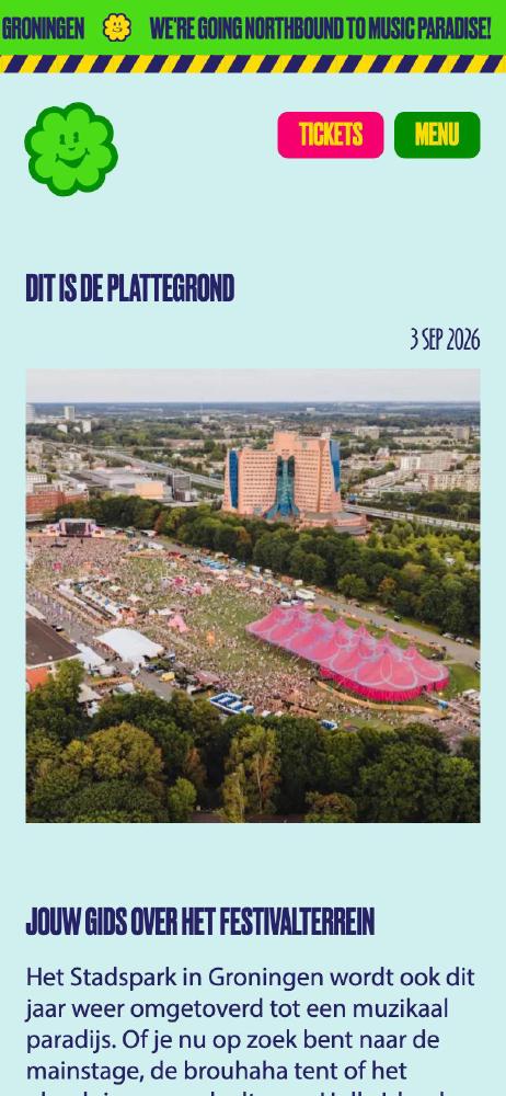 News article with the Hullabaloo Festival map on a phone