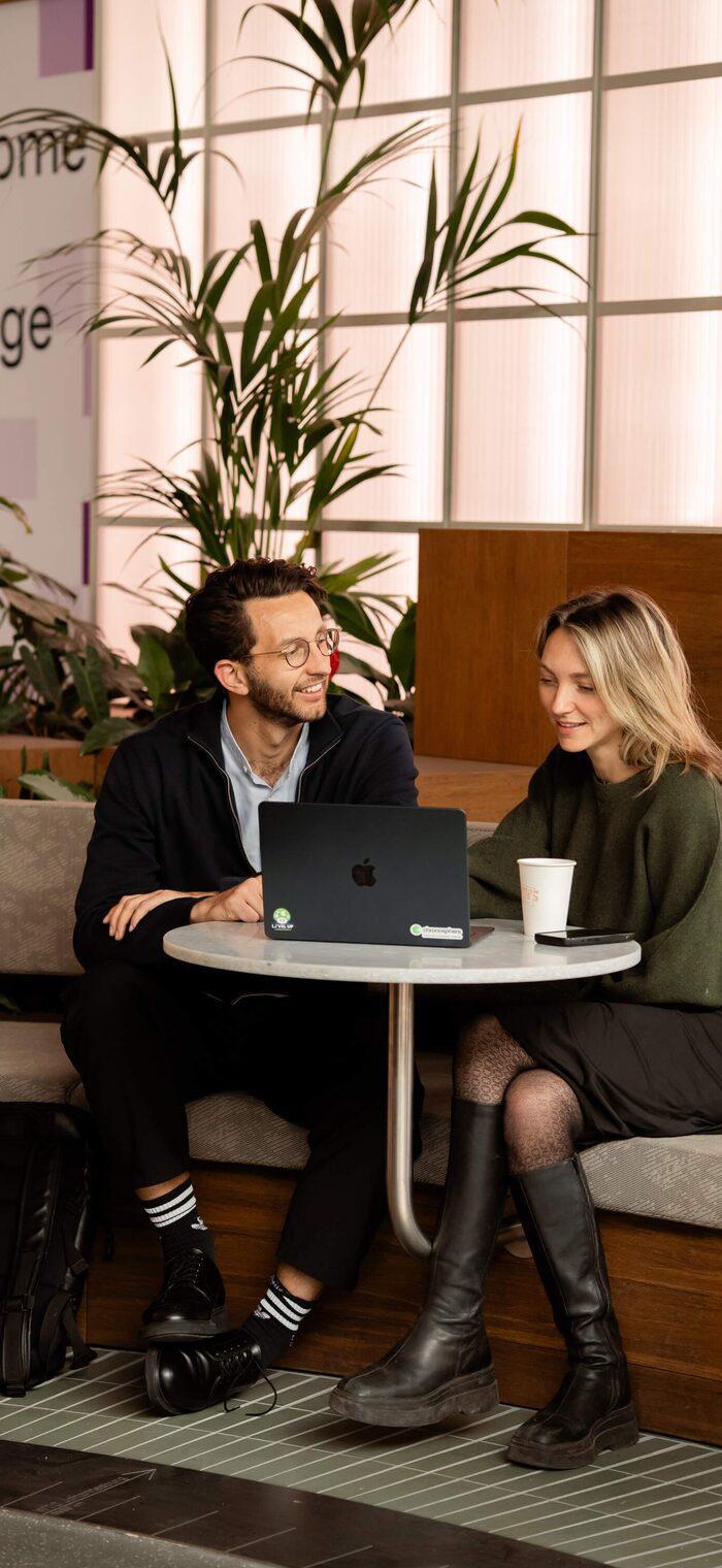 Two people working together in the WTC Amsterdam coworking space