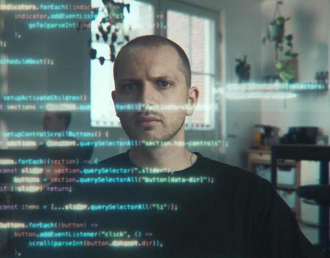 Developer behind a screen full of code
